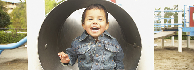 Native American boy playing in tunnel