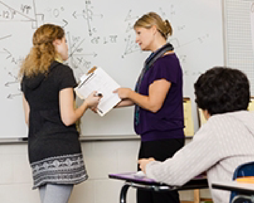 Image of teachers at whiteboard