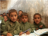 young boys with writing tablets in school
