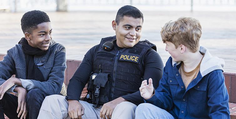 Police officer chatting with kids