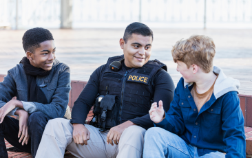 Police officer chatting with young people